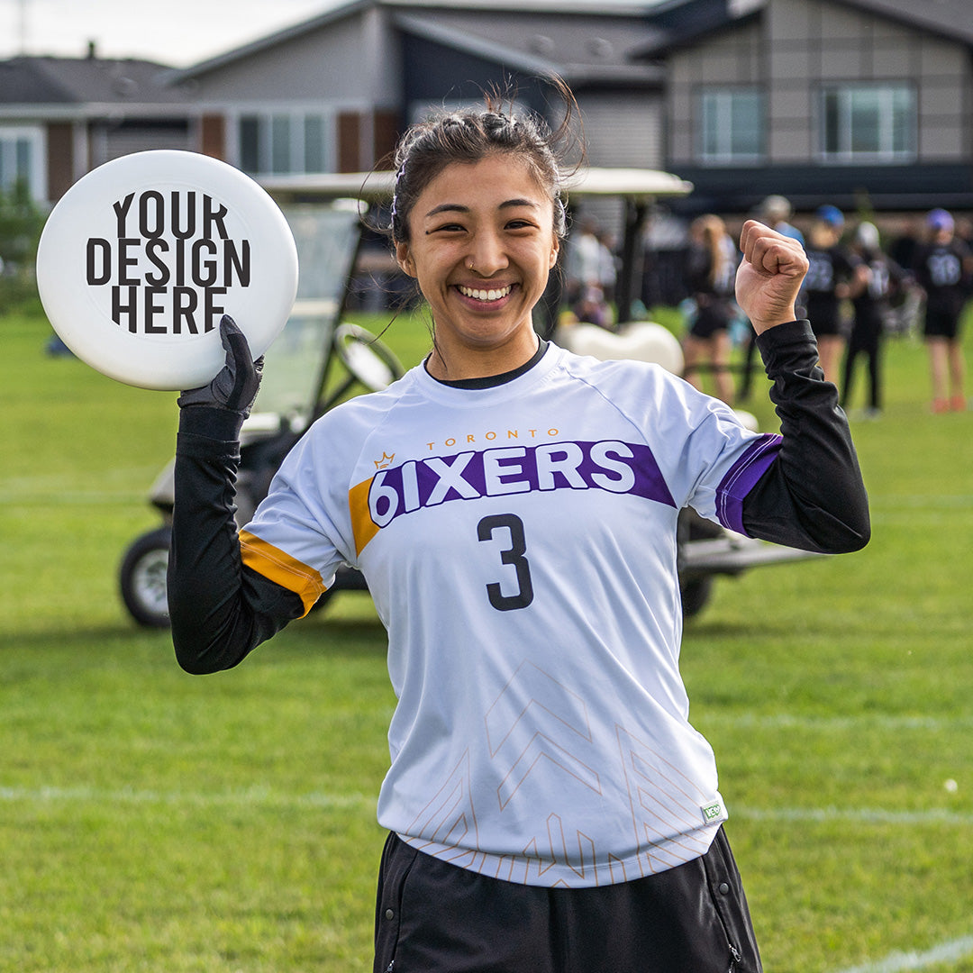 6ixers Ultimate Frisbee Player holding up Custom Discraft UltraStar